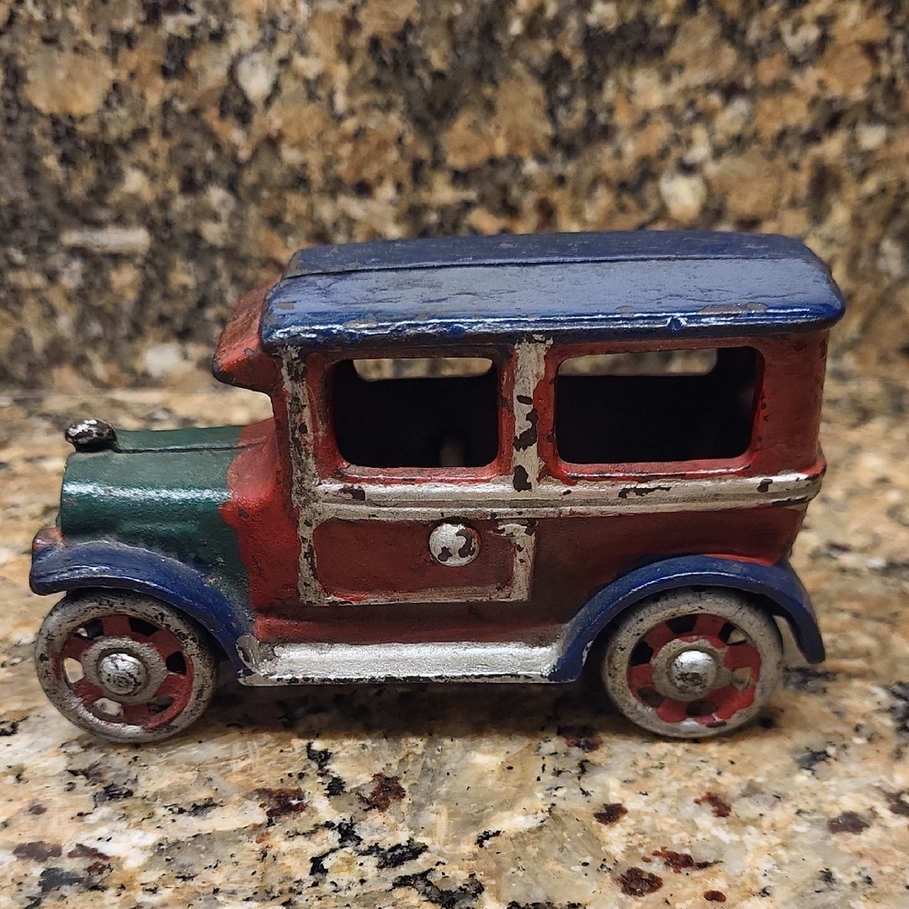 Vintage Cast Iron Toy Car with Red, Blue, and Green Accents